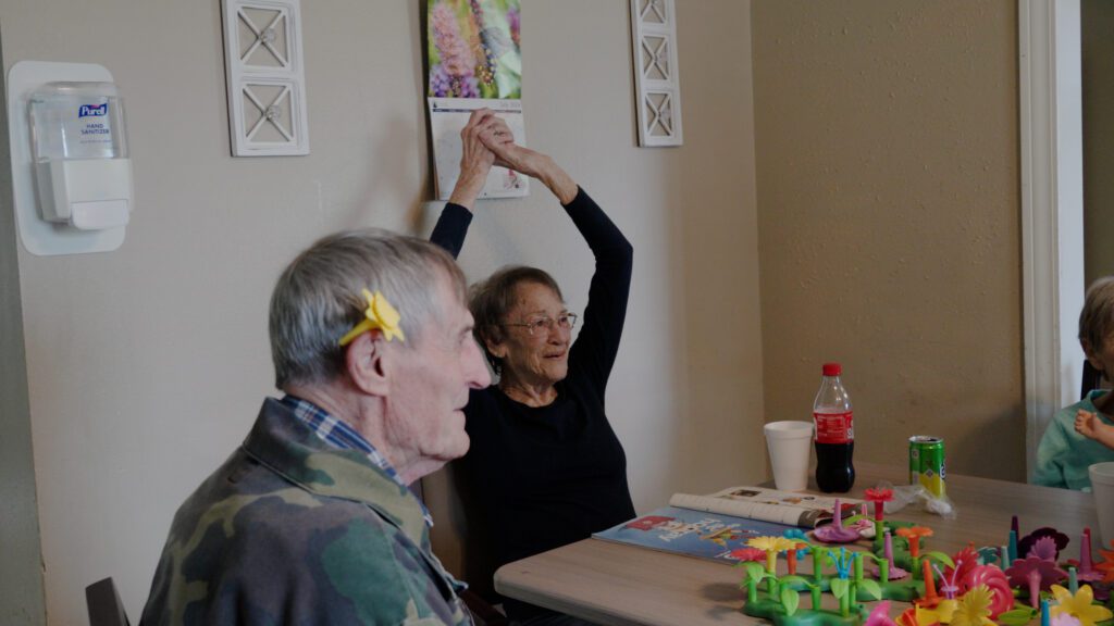 A group of people do memory care activities at Pioneer