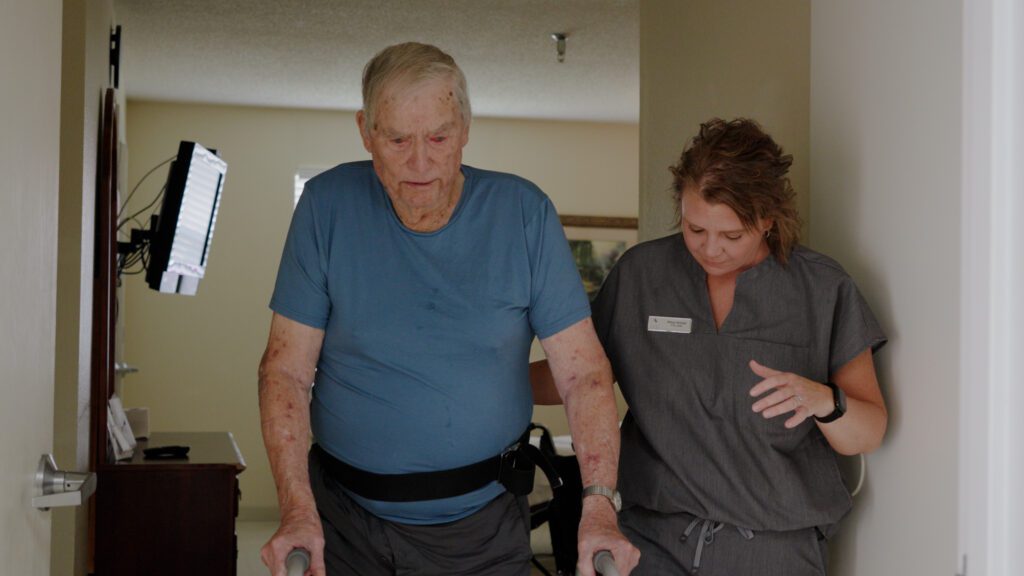 A nurse helps a man in a short term care program at Pioneer