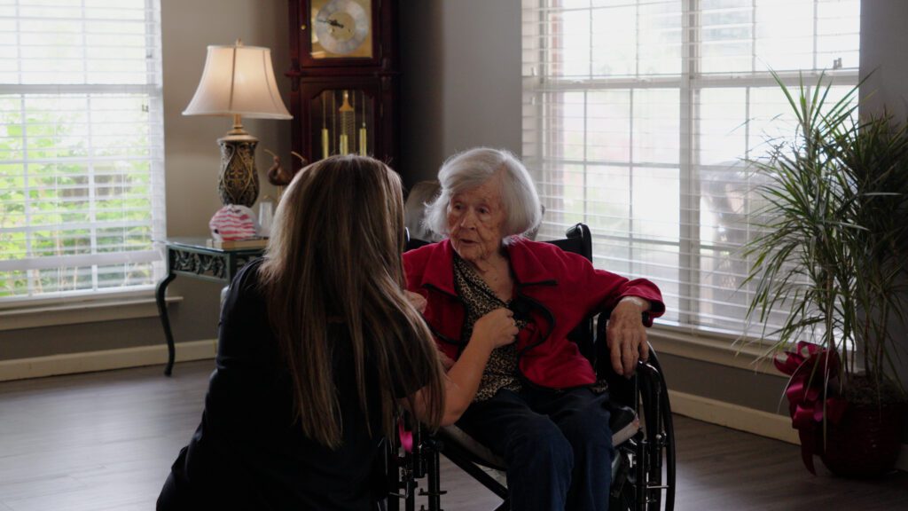A woman is talking to a nurse at a skilled nursing facility